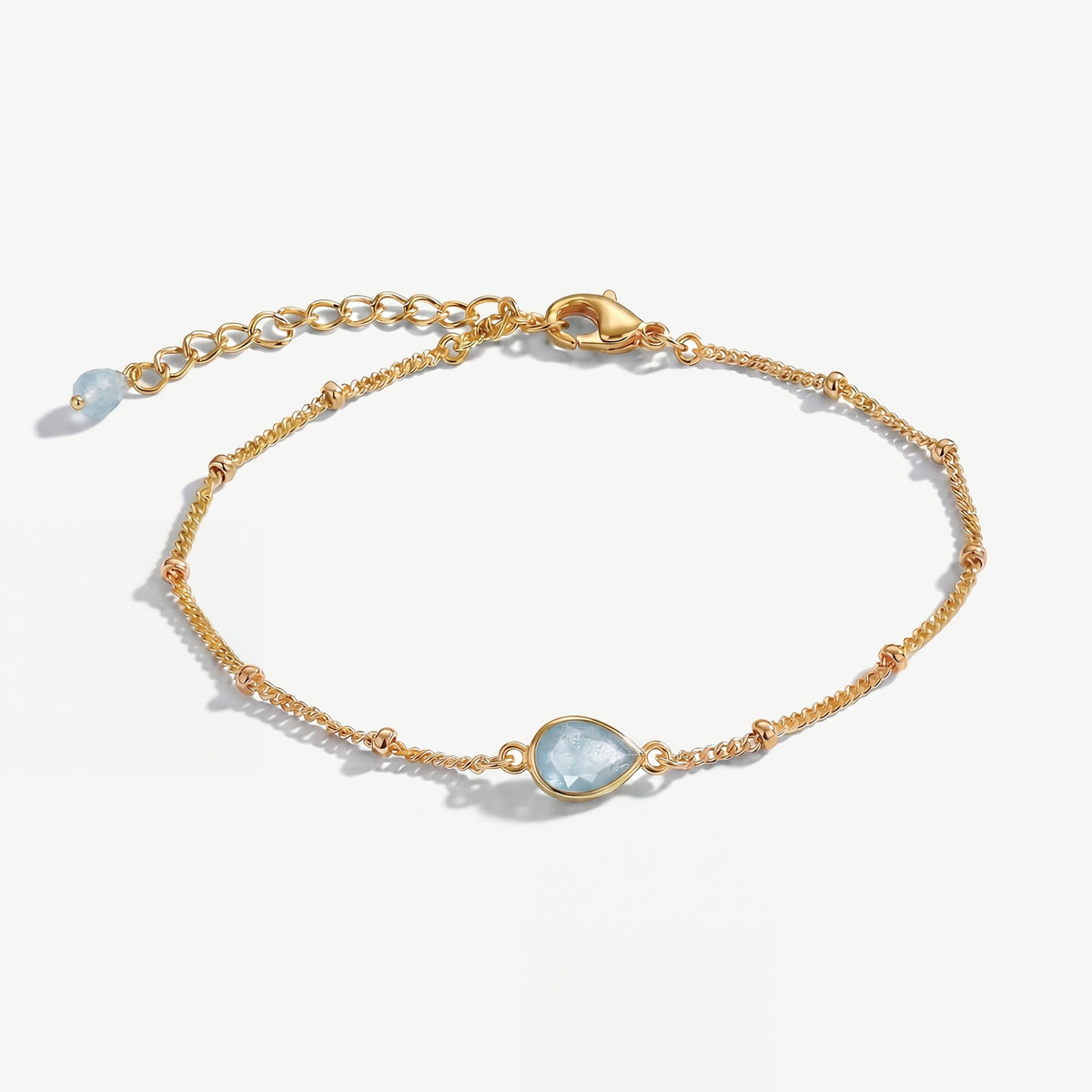 March aquamarine birthstone bracelet with pale blue teardrop gemstone on delicate gold bobble chain