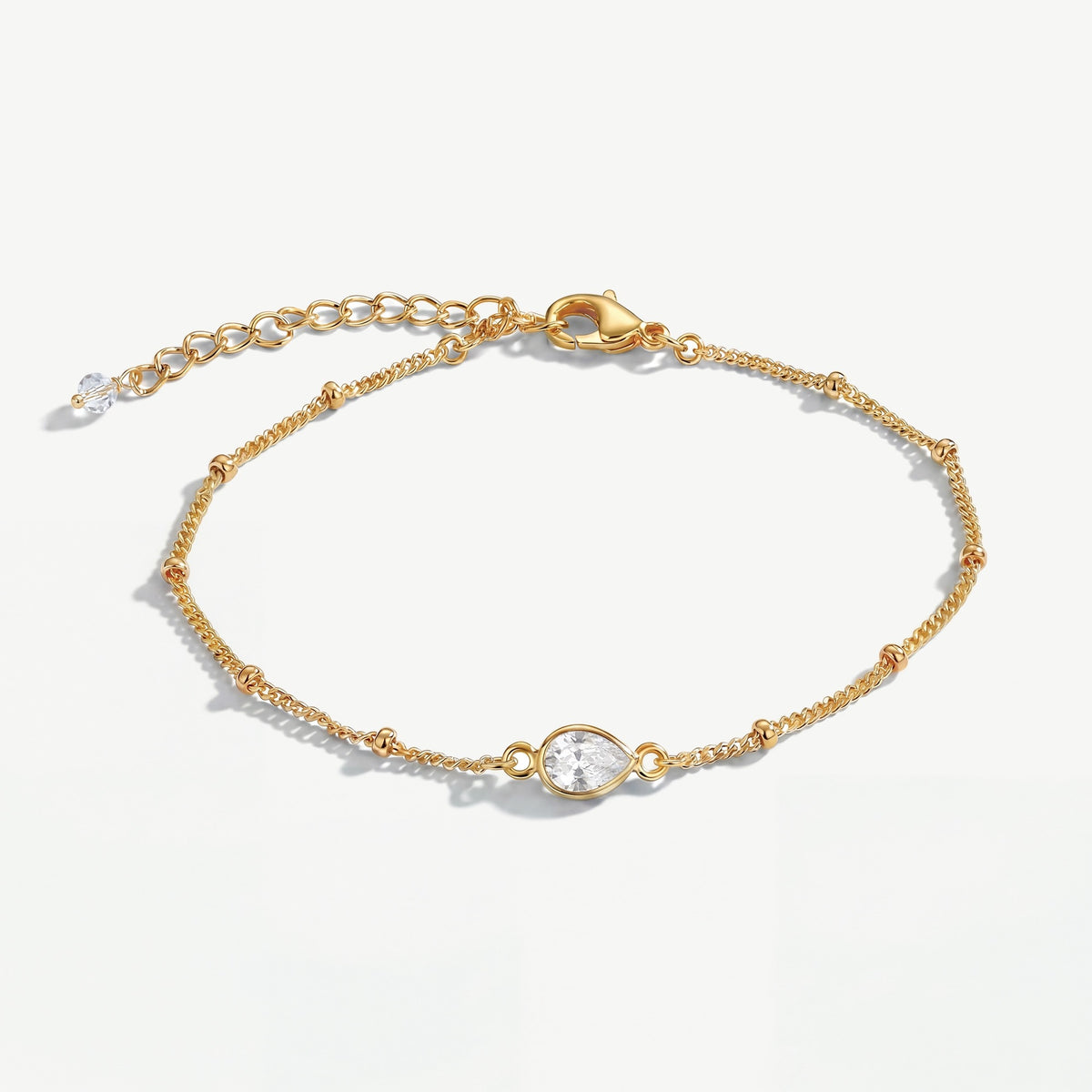 April white topaz birthstone bracelet with clear teardrop gemstone on delicate gold bobble chain