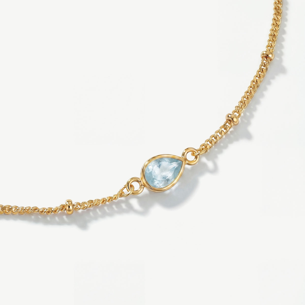 Genuine faceted aquamarine teardrop gemstone on 18ct gold plated birthstone bracelet