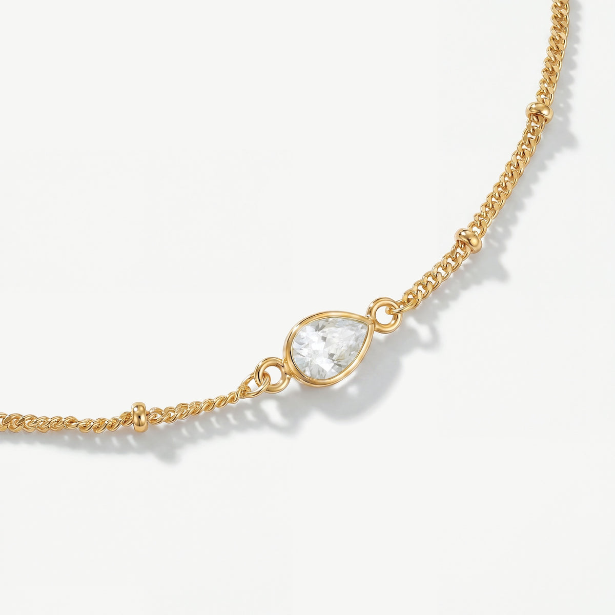 Genuine faceted white topaz teardrop gemstone on 18ct gold plated birthstone bracelet